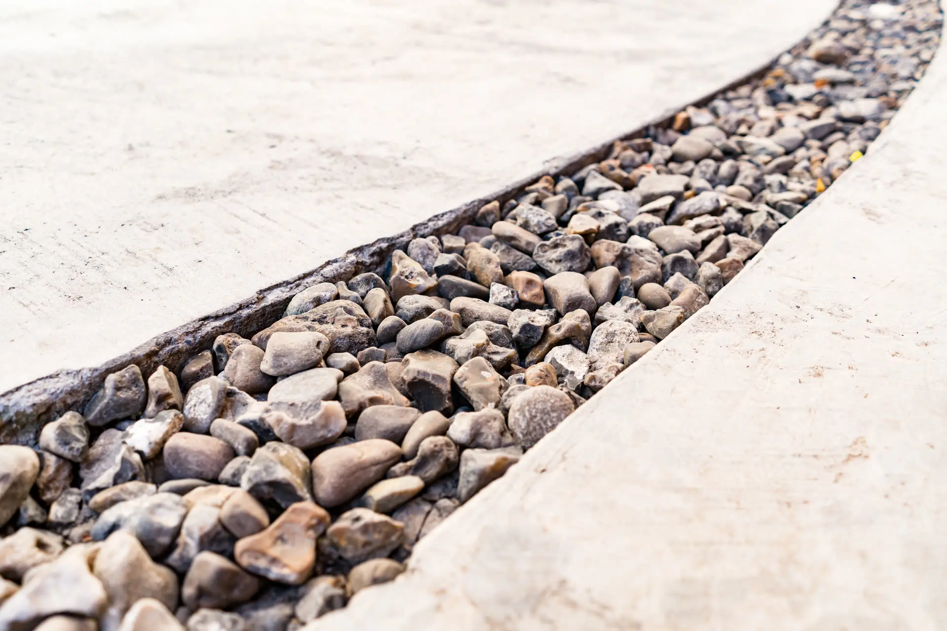 Stormwater drainage channel with gravel and concrete edging