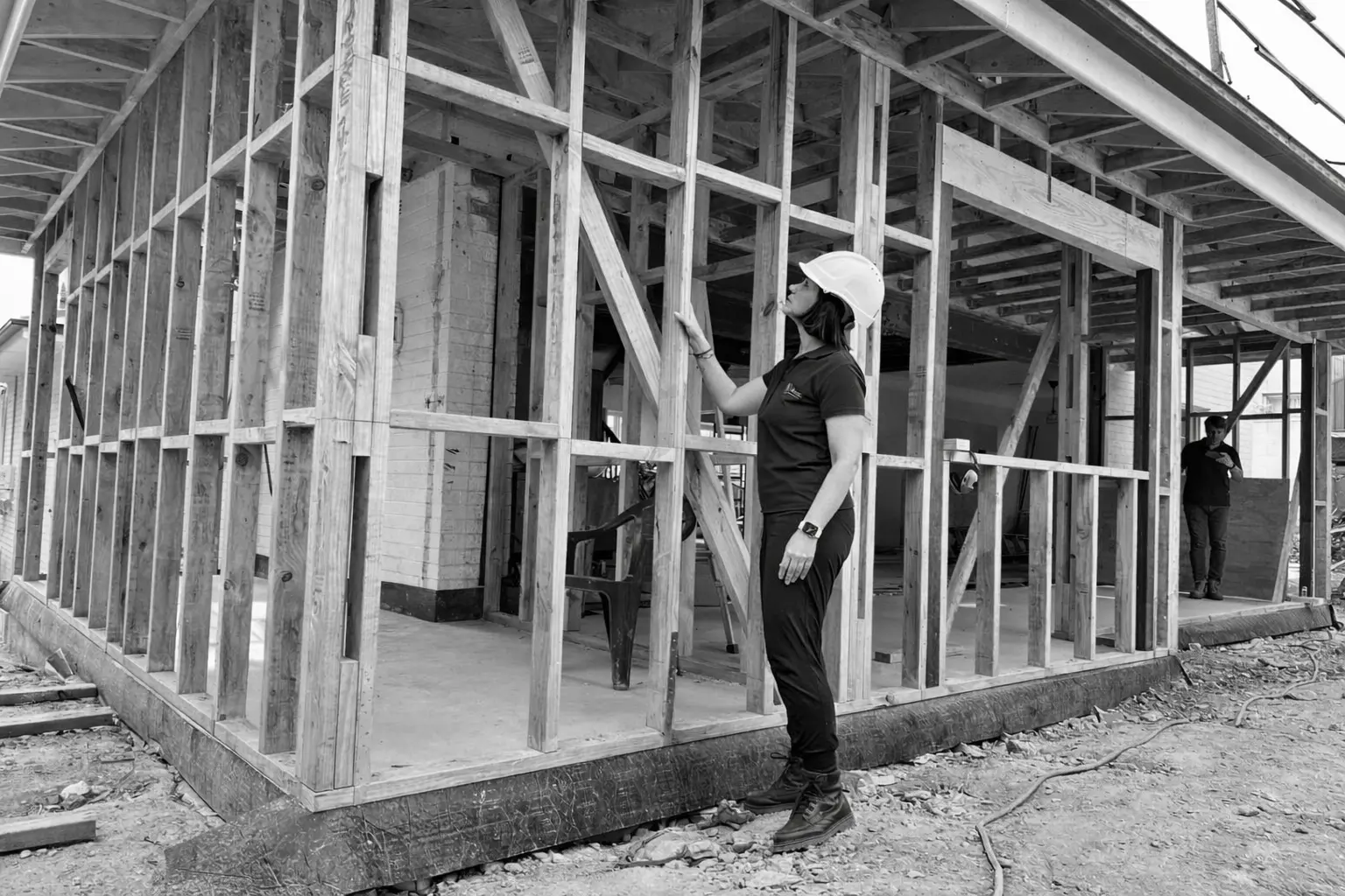 Load-bearing wall assessment — engineer inspecting timber wall framing on site